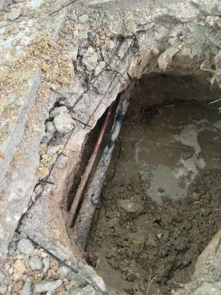 Slab leak repair - Twin Eagles Plumbing exposing a leaking copper line under concrete in Southwest Florida